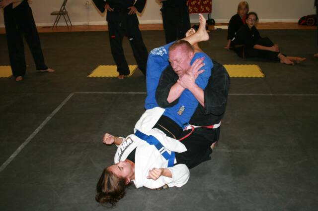 Amanda help Mr. Hatcher teach the triangle choke escape